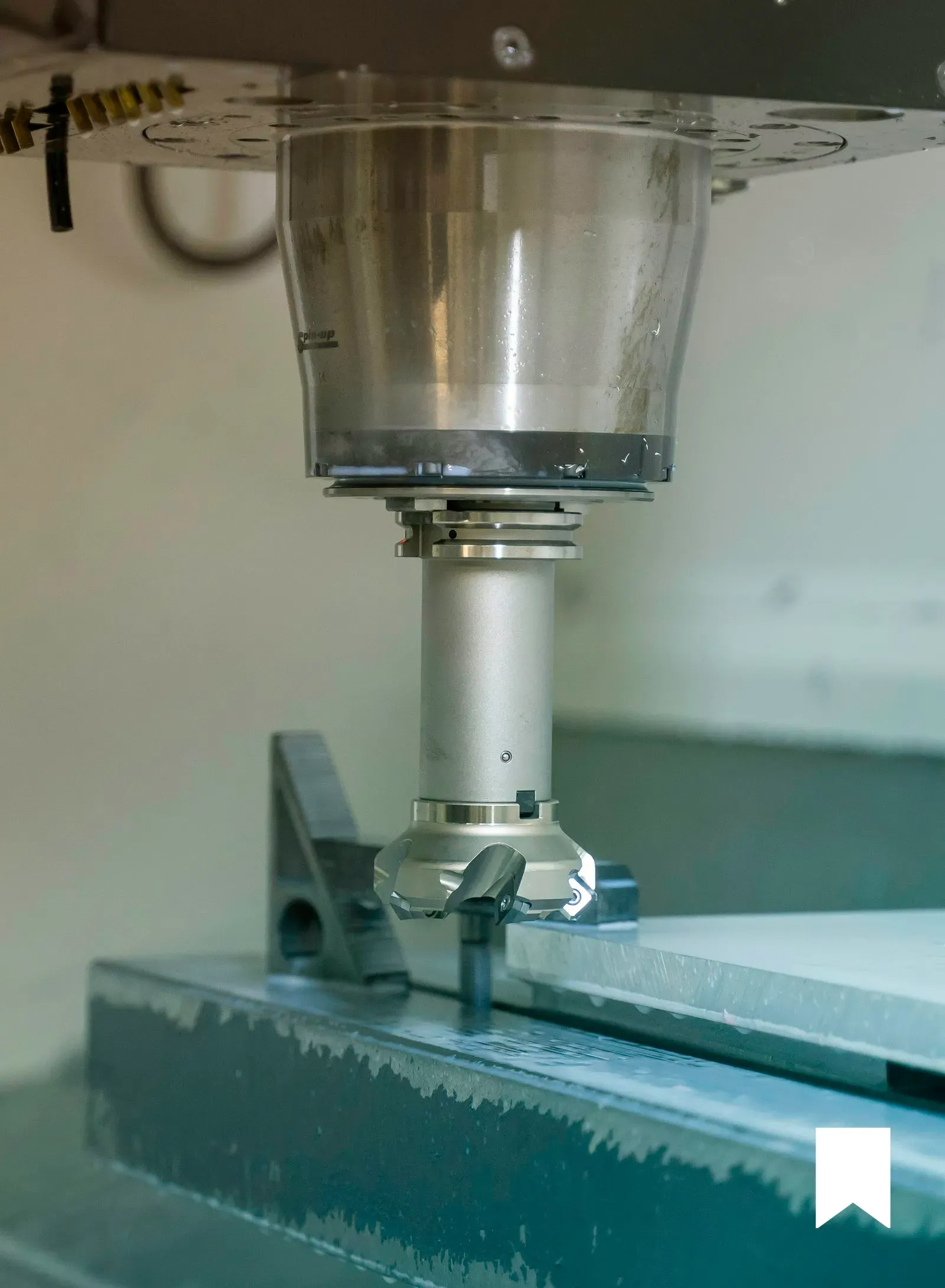 CNC milling machine performing precision cutting operation on metal workpiece