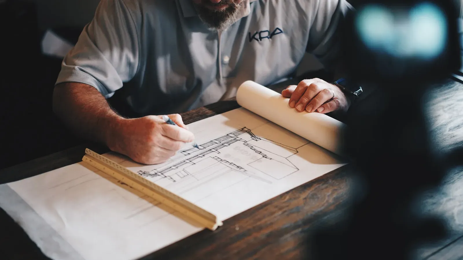 Engineering drawing with GD&T callouts and precision measuring equipment