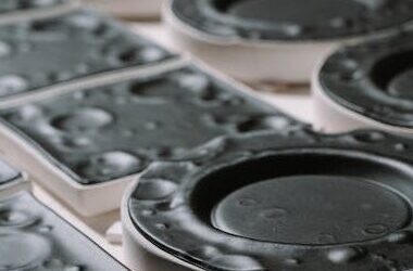 Detailed image of black plastic injection molds used in manufacturing industry.