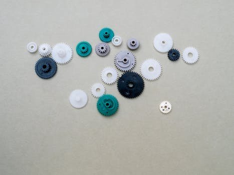 A collection of colorful plastic gears arranged on a plain surface, ideal for mechanical or DIY concepts.