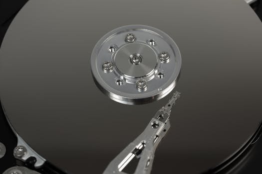 Detailed macro shot of hard drive platters and arm mechanism, showcasing intricate engineering.